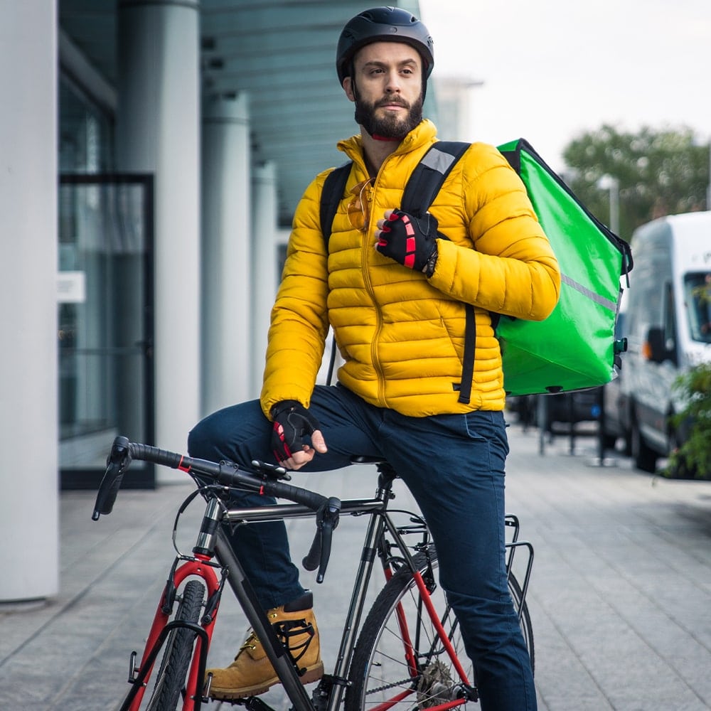 Delivery man with a bike at Original India takeaway in Larkhall 